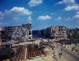 19 Jul 1945, Berlin, Germany --- Berlin: Germany: German citizens can be seen walking over a bridge amid the ruins of buildings. Twisted metal frames are visible through the walls of bombed buildings along the streets of Berlin. A bus can also be seen crossing the bridge. --- Image by © Bettmann/CORBIS